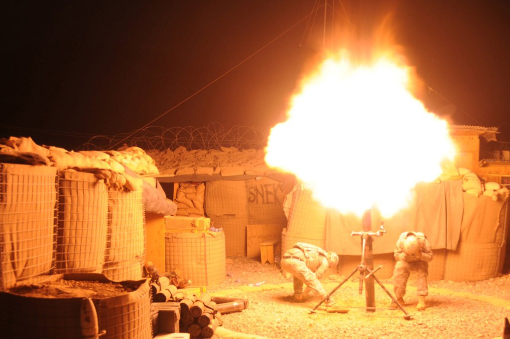 Spc. Patrick Wilson (left) and Spc. Evaristo Garcia fire a 120 mm high-explosive mortar round during a coordinated illumination exercise at Forward Operating Base Mizan, Afghanistan, on Sept. 2, 2009.