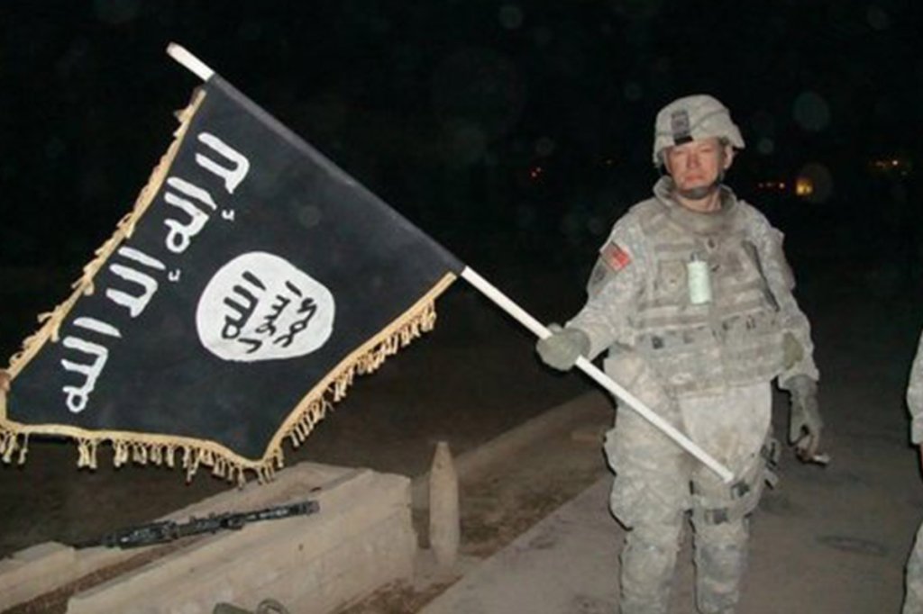 Lt. Col. Rod A. Coffey, 2nd Cavalry Regiment, with captured Islamic State of Iraq flag in Iraq's Diyala Province, March 2008
