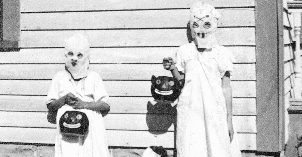A trio of kids dressed up as ghosts are ready for trick or treating. (Photo by Kirn Vintage Stock/Corbis via Getty Images)