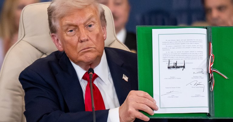 President Donald Trump shows the signed peace treaty at the Gaza summit chaired by Egypt's President Al-Sisi, on Oct. 14, 2025.