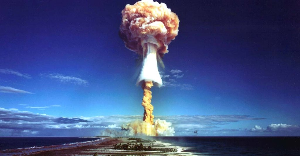 A tall mushroom cloud rises over the Pacific at Bikini Atoll after World War II.