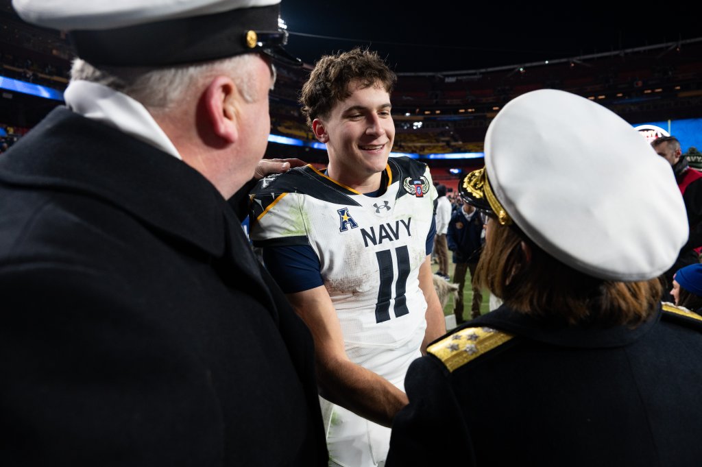 Chief of Naval Operations Adm. Lisa Franchetti and Master Chief Petty Officer of the Navy James Honea, congratulate the U. S. Naval Academy football team quarterback Midshipman 2nd Class Blake Horvath after the win of the Army-Navy football game at Northwest Stadium in Landover, MD, December 14, 2024. This is the 125th meeting between the U.S. Naval Academy Midshipmen and the U.S. Military Academy Black Knights. (U.S. Navy photo by Chief Mass Communication Specialist Anna E. Van Nuys)