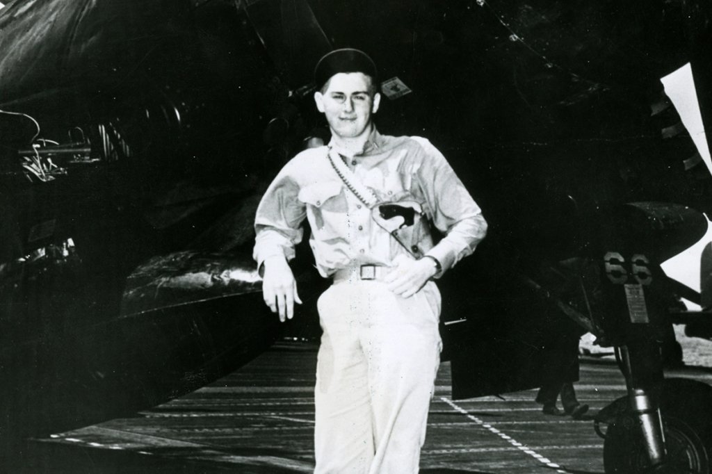 U.S. Navy Ensign Albert Lerch, fighter ace, leans on an aircraft, PTO, 1945