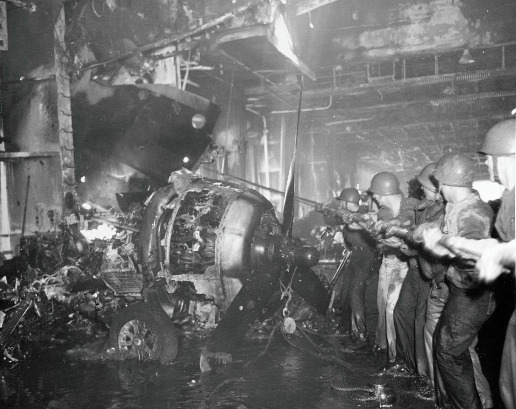 USS INTREPID (CV-11) Caption: Crewmembers clearing away wreckage in the hangar deck after the ship was hit by Kamikaze's off the Philippines, 25 November 1944. Description: Catalog #: 80-G-270840 Copyright Owner: National Archives Original Creator: Original Date: Sat, Nov 25, 1944 After this Year: 1939 Before this Year: 1945 Original Medium: BW Photo