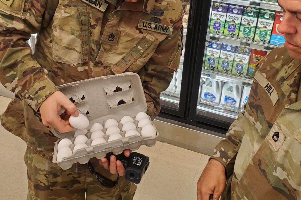 Staff Sgt. Matthew Milligan, a Veterinary Food Inspection Specialist (68R) with the 445th Medical Detachment (Veterinary Services), inspects eggs for quality and safety at the McGuire Commissary in July during WAREX 25 at Joint Base McGuire-Dix-Lakehurst. While WAREX, a two-week field exercise, focuses on sharpening basic soldiering skills in austere conditions, the 445th MDVS also trained on their mission set of safeguarding food supplies, supporting military working dogs, and ensuring animal health and assisting at the base vet treatment facility. (U.S. Army Reserve photo by Lt. Col. Ellen Ratcliff)