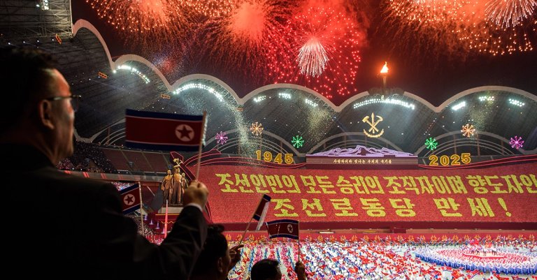 TOPSHOT - Fireworks light up the sky as spectators react during the "Long Live the Workers' Party of Korea" performance to celebrate the 80th founding anniversary of the Workers' Party of Korea at the May Day Stadium in Pyongyang on October 9, 2025. (Photo by KIM Won Jin / AFP) (Photo by KIM WON JIN/AFP via Getty Images)