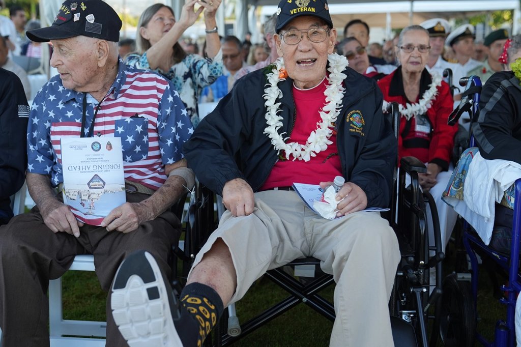 A World War II veteran shows off his socks while waiting for the 83rd National Pearl Harbor Remembrance Ceremony to commence at Pearl Harbor National Memorial in Honolulu Dec. 7, 2024. (U.S. Coast Guard/Petty Officer 3rd Class Jennifer Nilson)