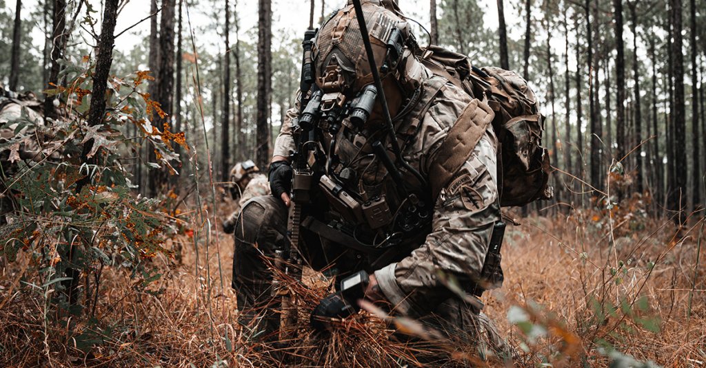 A U.S. Army Green Beret assigned to 3rd Special Forces Group (Airborne) gathers vegetation to conceal his team's position before an ambush drill as part of a validation exercise on Fort Bragg, N.C., Oct. 29, 2025. A VALEX validates the company's operational proficiency through integrated training with partner forces, bolstering interoperability and readiness to ensure effective combined operations in support of national security objectives. (U.S. Army photo by Pfc. Edgar Martinez)