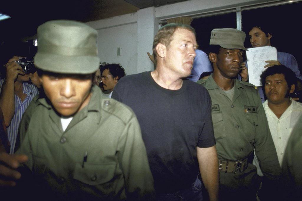 US Airman Eugene Hasenfus being escorted by guards during his trial. He was captured while flying arms to contras. (Photo by Cindy Karp/Getty Images)