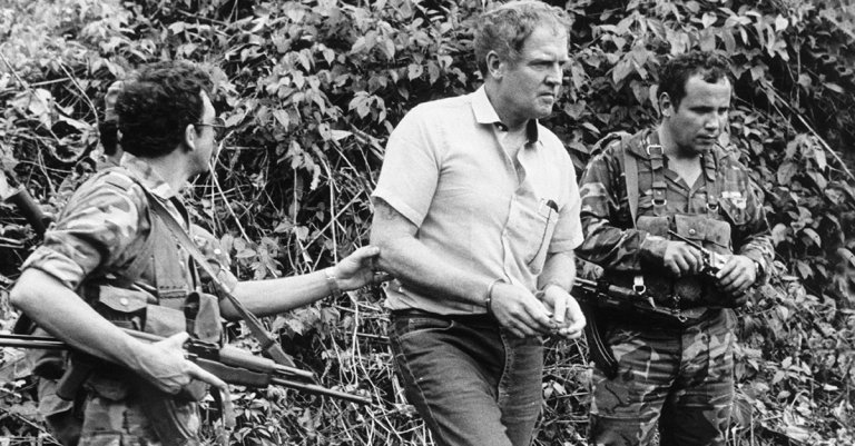 Before his trial, American prisoner Eugene Hasenfus is led by two Sandinista guards to the place where his plane was shot down. (Photo by claude Urraca/Sygma via Getty Images)