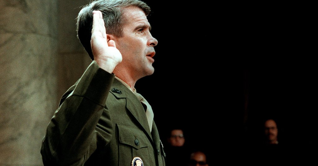 Lieutenant-Colonel Oliver North, former aide to former National Security Adviser John Poindexter, is sworn in 07 July 1987 before the House and Senate Foreign Affairs Committee hearing in Washington, D.C. on arms sales to Iran and diversion of profits to Nicaraguan Contra rebels. North testified under limited immunity. The "Irangate" saga erupted 30 November 1986 into a new crisis for the US President Reagan administration with the resignation of Admiral John Poindexter as the President's National Security Advisor and the dismissal of North, a member of the National Security Council Staff. "Ollie" North, a much-decorated Marine officer, known to White House cynics as the President's "Swashbuckler in Chief", was linked to the transfer of some $ 30 million profit from the Iran weapons sales to Contra rebels fighting the left-wing Sandinista government in Nicaragua. (Photo credit should read CHRIS WILKINS/AFP via Getty Images)