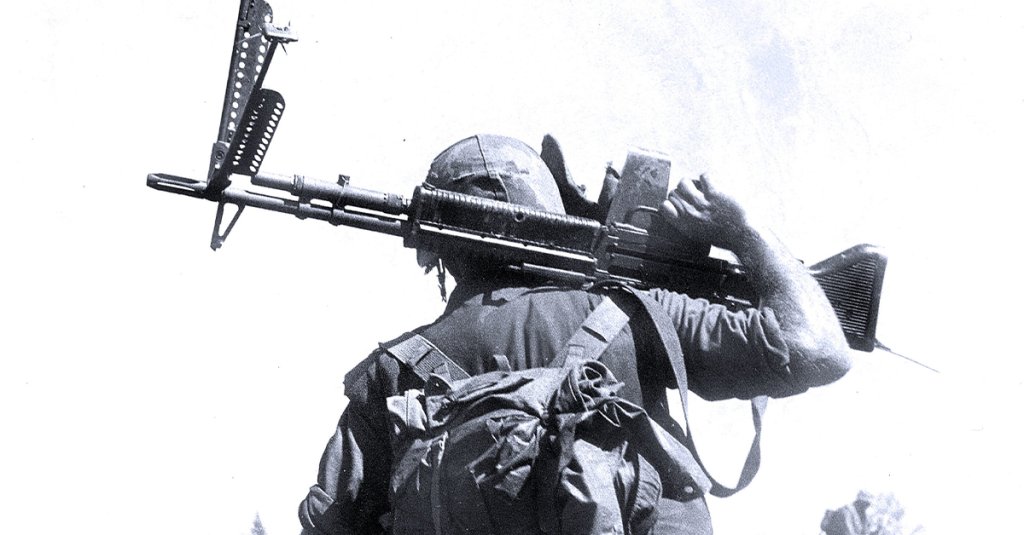 Marines crossing a rice paddy while on patrol, holding an M-60 machine gun in Vietnam, 1966. (PhotoQuest/Getty Images)