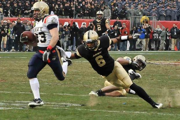 Navy sophomore John Howell breaks a tackle attempt by Army defensive back Donovan Travis after catching a 77-yard pass during the 111th Army-Navy Game at Lincoln Financial Field in Philadelphia on Dec. 11, 2010. (U.S. Army/1st Sgt. Robert Hyatt)