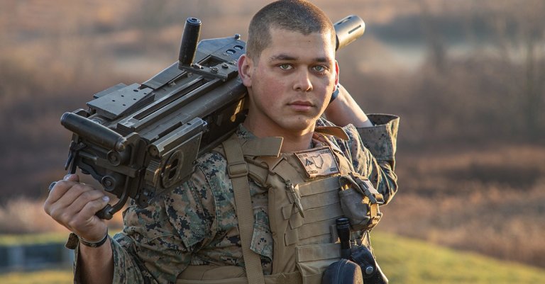 U.S. Marine Corps Lance Cpl. Isaiah Schwab, a combat engineer, holds a mark 19 grenade launcher over his shoulder before a Mk-19 live fire range at Fort Drum, New York. (U.S. Marine Corps/Lance Cpl. Scott Jenkins)