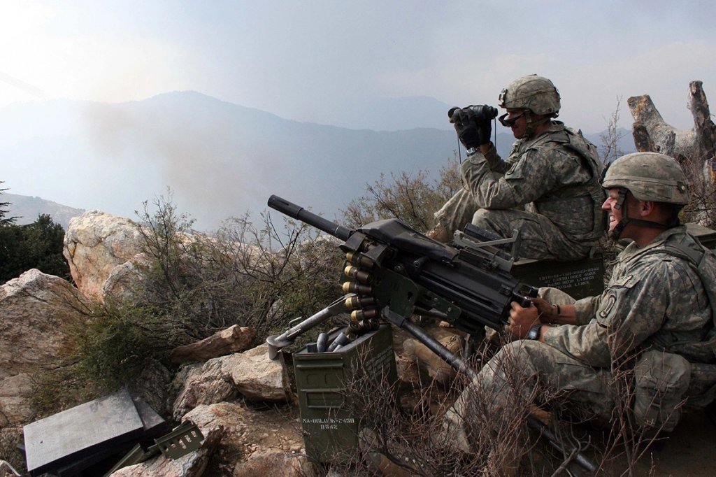 Sgt. Chad Mohr, left, St. Louis, Mo., watches rounds land on target as Spc. David Hooker, right, Palestine, Ark., fires the MK19 machine gun at a known insurgent position, Oct. 24, during Operation Rock Avalanche. The "Dragon Platoon" Soldiers of Destined Company, 2nd Battalion, 503rd Infantry (Airborne) were occupying a ridgeline between the Pech and Shuryak Valleys in Kunar province, Afghanistan