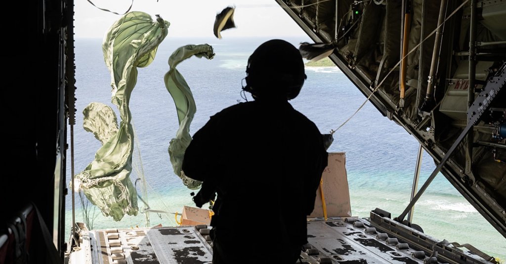 U.S. Air Force Senior Airmen Ivan Lucero, loadmaster with the 36th Airlift Squadron from Yokota Air Base, Japan, drops a bundle out of a C-130J Super Hercules aircraft during Operation Christmas Drop 2024 over the Micronesian Islands, Dec. 8, 2024. OCD aims to build and enhance the coordination, integration, and execution skills necessary to support future humanitarian assistance efforts in the region. (U.S. Air Force photo by Ms. Theresa Valadez)