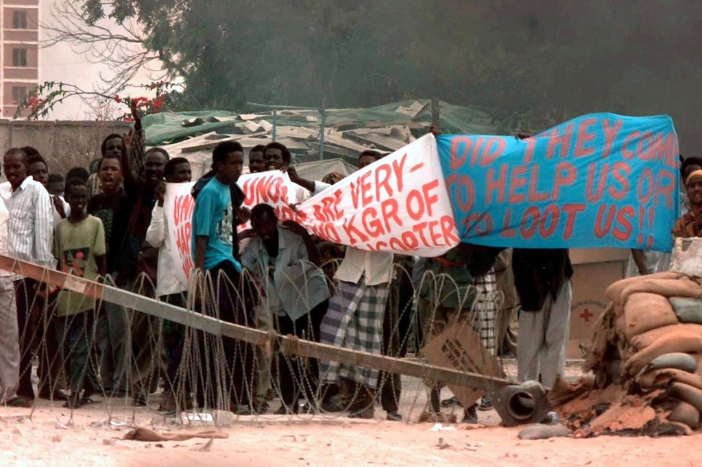 Somali people hold up a banner in protest at gate eight of the US Embassy in Mogadishu. They seem to be protesting the existence of coalition forces assigned to Operation Restore Hope. (U.S. Army/Spc. Michael Halgren)