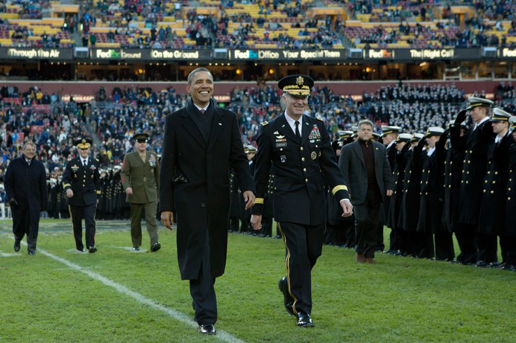 During an Army-Navy Game halftime ceremony, President Barack Obama is transferred from the U.S. Naval Academy's custody to the custody of the U.S. Military Academy on Dec. 10, 2011. (White House Photo by Pete Souza)