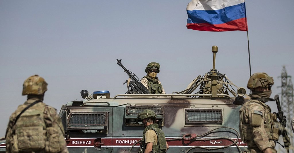 US soldiers stand near a Russian military vehicle in the northeastern Syrian town of al-Malikiyah (Derik) at the border with Turkey, on June 3, 2020. (Photo by DELIL SOULEIMAN / AFP) (Photo by DELIL SOULEIMAN/AFP via Getty Images)