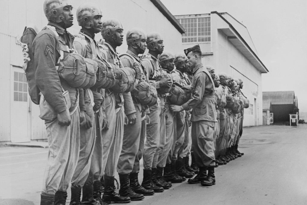A drill instructor during an inspection of paratroopers at Fort Benning in Chattahoochee County, Georgia, 24th February 1944. Some of the paratroopers are named (but not identified) as Corporal Elijah H Wesby, Sergeant Robert S Walden, Sergeant Jack D Tillis, and Sergeant Daniel Weil. (Photo by Keystone/Hulton Archive/Getty Images)