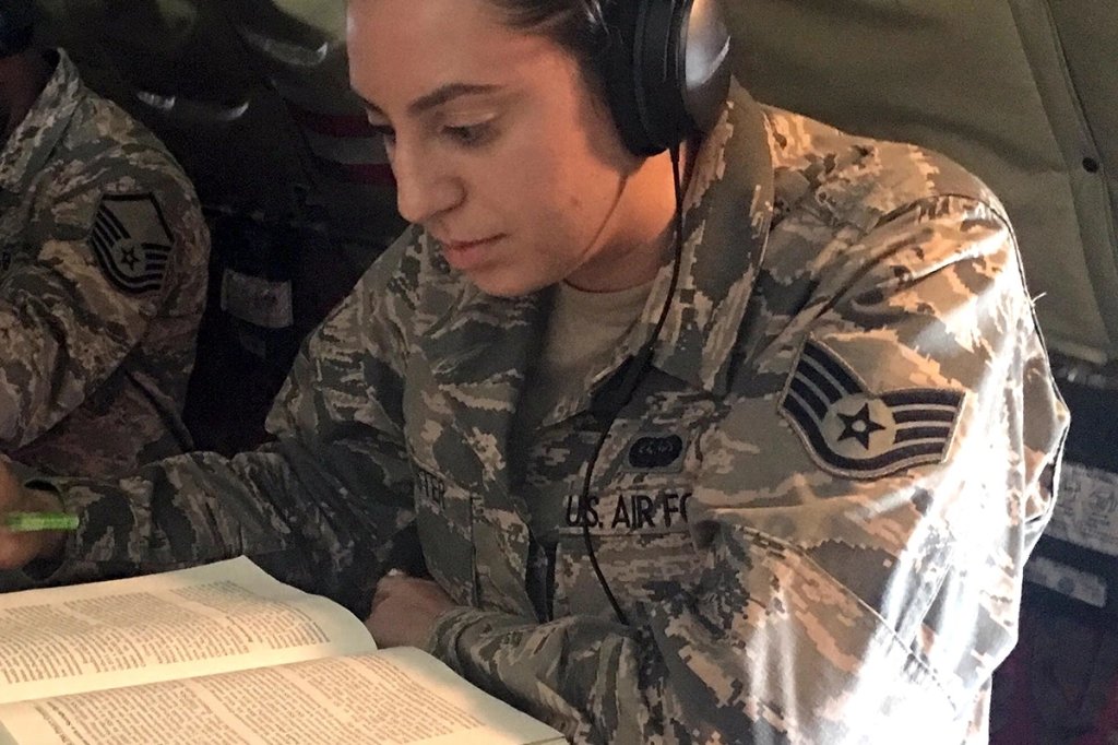 Senior Airman Jamie Foster works on homework during a flight aboard a KC-135 Stratotanker
