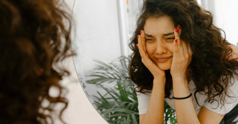 woman crying in mirror deployed spouse depression