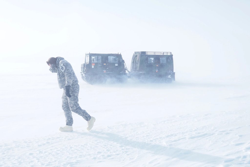 A Soldier braves whiteout conditions in a field near Barrow Alaska
