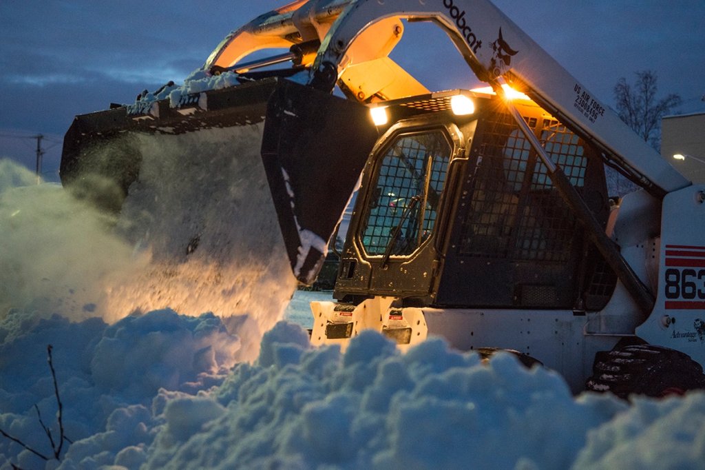A bobcat moves snow after the first heavy snowfall of the season at Joint Base Elmendorf-Richardson.
