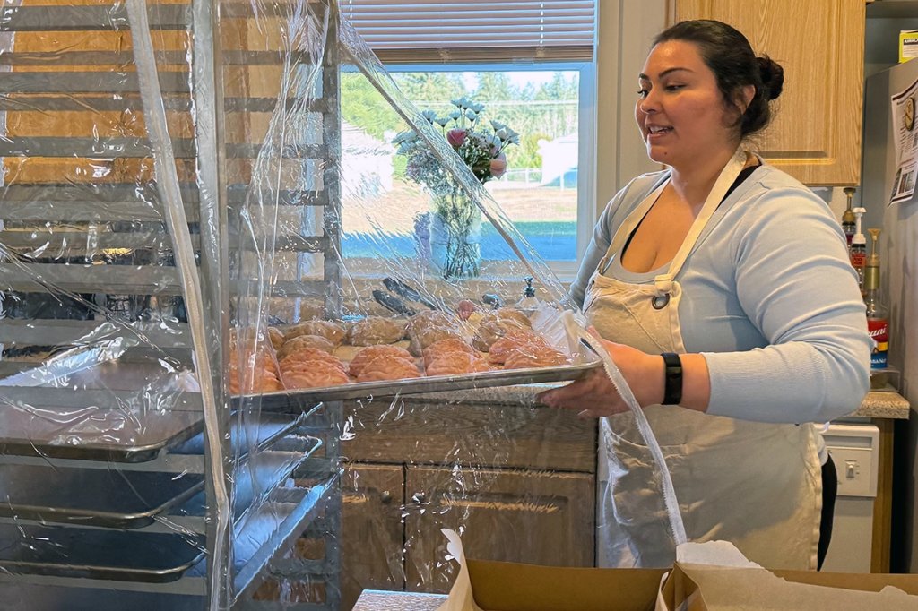 Army spouse Lupe Najarro prepares to box a tray of Mexican sweet bread (conchas) Feb. 11 to sell on Joint Base Lewis-McChord