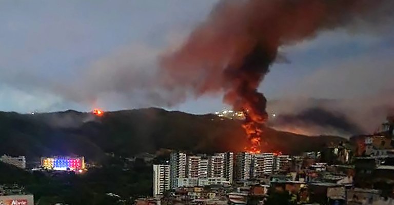 venezuela air defense Fire at Fuerte Tiuna, Venezuela's largest military complex, is seen from a distance after a series of explosions in Caracas on January 3, 2026. (AFP via Getty Images)