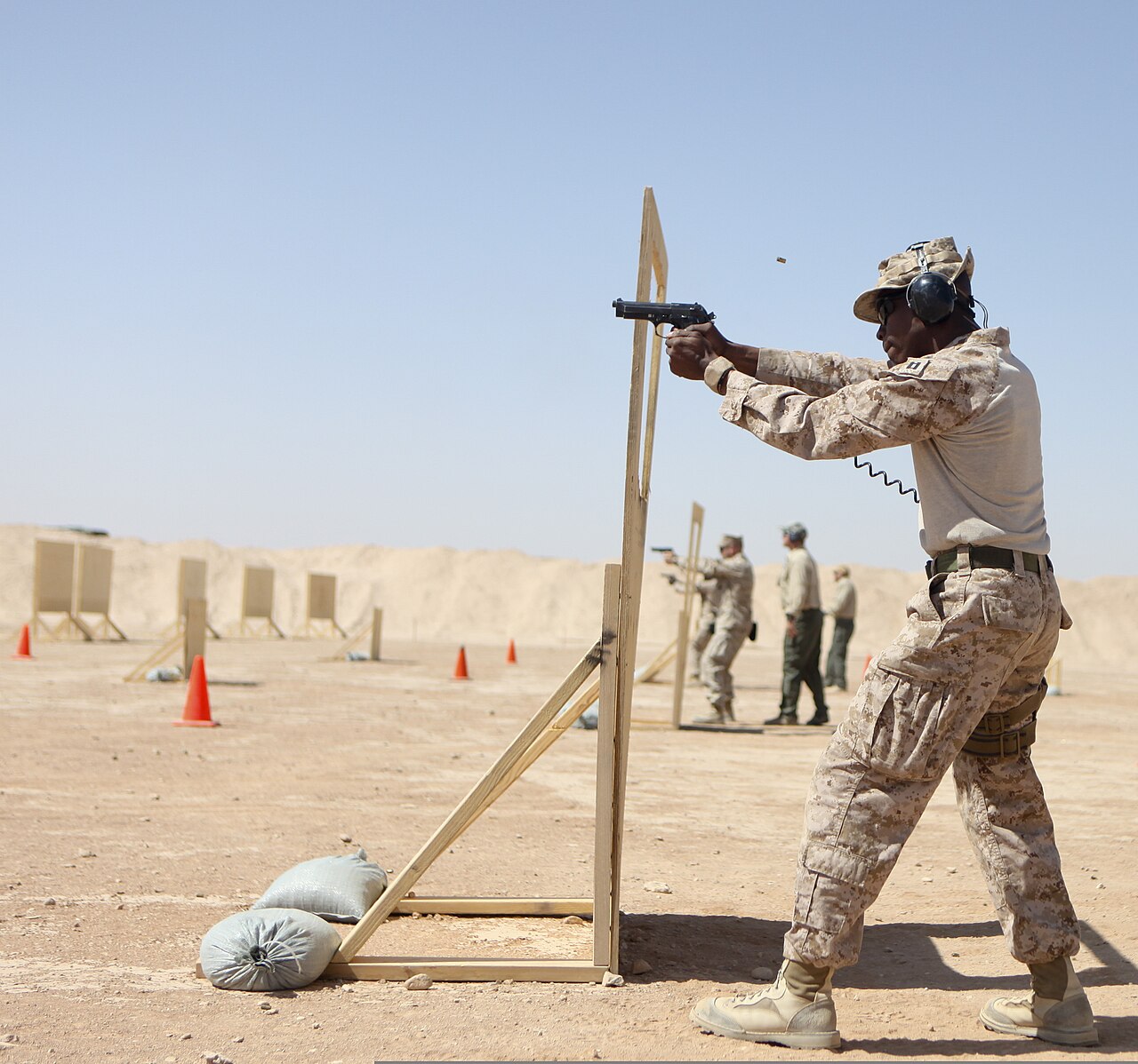 U.S. Marine Corps Capt. Orlando Higgins, foreground, with Regional Command Southwest, fires an M9 pistol Oct. 3, 2013, during a weapons marksmanship course at Camp Leatherneck, Afghanistan. (U.S. Marine Corps photo by Sgt. Bobby J. Yarbrough/Released) Modern pistol technique Jeff Cooper