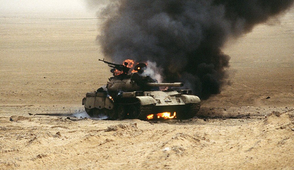 An Iraqi Type 69 main battle tank burns after an attack by the 1st United Kingdom Armored Division during Operation Desert Storm.
