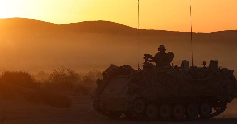 U.S. Soldiers assigned to 4th Squadron, 9th Cavalry Regiment, 2nd Armored Brigade Combat Team, 1st Cavalry Division maneuver over terrain in a M113 Armored Personnel Carrier during Decisive Action Rotation 22-06 at the National Training Center, Fort Irwin, Calif. April 7, 2022. Rotations at the National Training Center ensure Army Brigade Combat Teams remain versatile, responsive, and consistently available for current and future contingencies. (U.S. Army photo by Sgt. Ryan Gosselin, Operations Group, National Training Center)