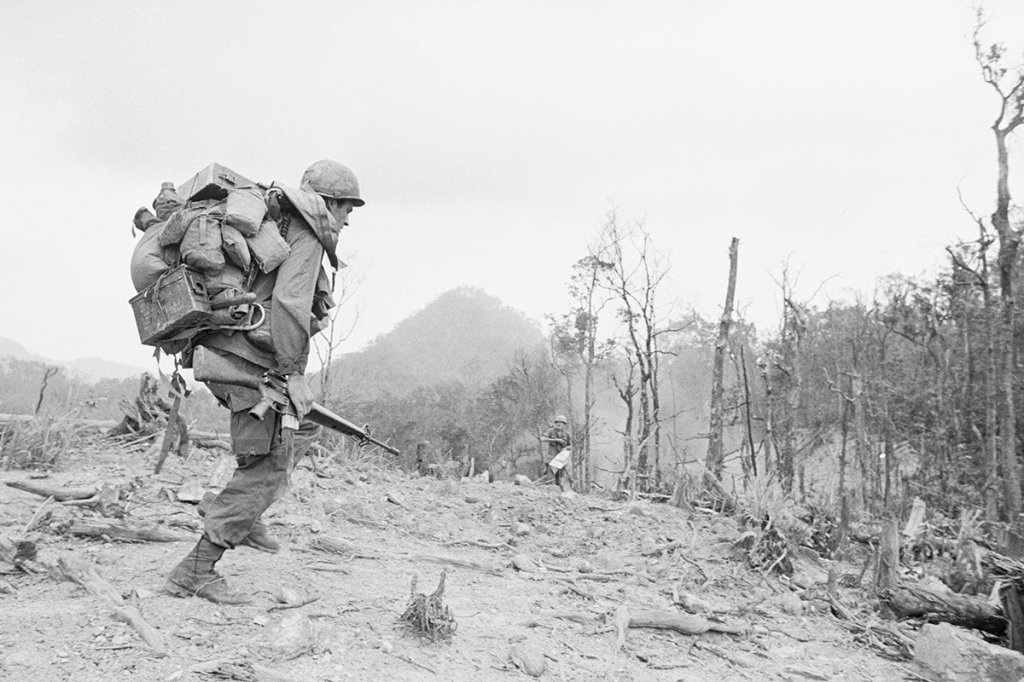 Soldiers assistant gunner ammo bearer vietnam of the 101st Airborne Division jump from a helicopter, April 27, during assault about five miles north of the A Shau Valley.