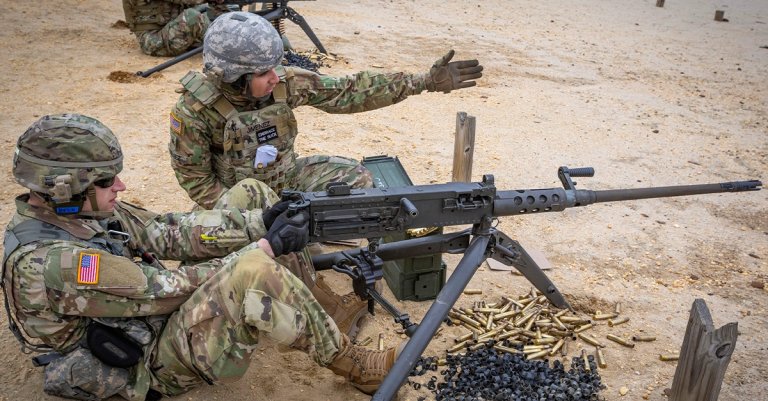 U.S. Army 1st Lt. Robert J. Beck, left, prepares to fire a M2 .50 caliber machine gun while Sgt. Jose M. Jimenez-Baez, both with the 50th Chemical Company, New Jersey Army National Guard, indicates which targets to fire at during the unit’s annual training at Joint Base McGuire-Dix-Lakehurst, N.J., May 1, 2019. (New Jersey National Guard photo by Mark C. Olsen)