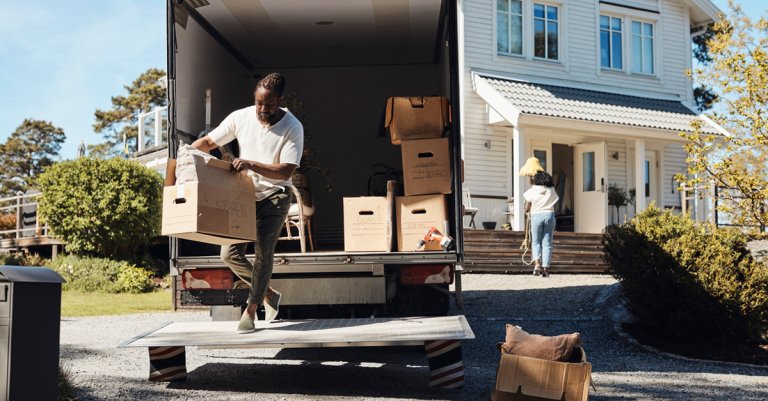 man unloading cardboard box from van
