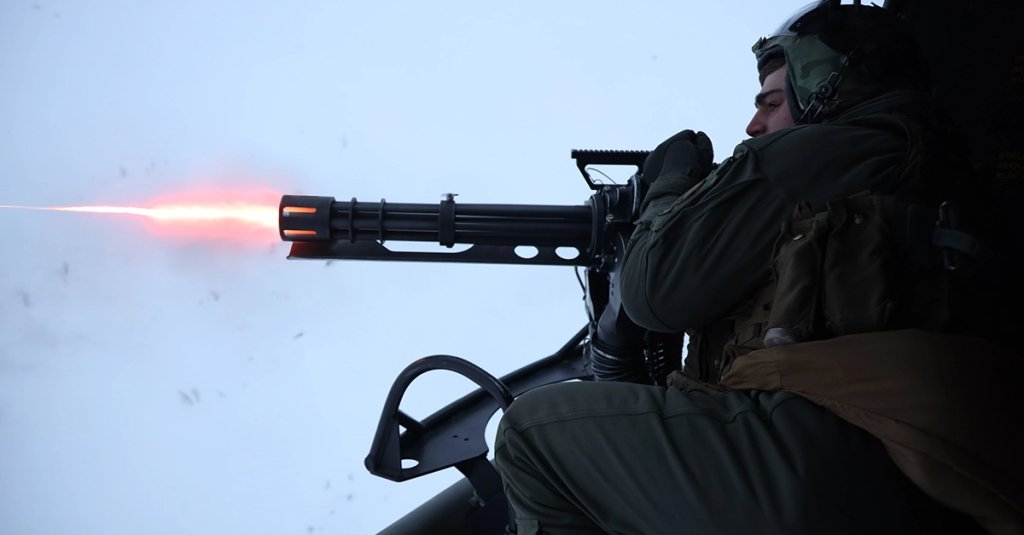 U.S. Marine Corps Sgt. Gage Garcheau engages a target with a M134 GAU-17/A minigun during Exercise Cold Response 2022