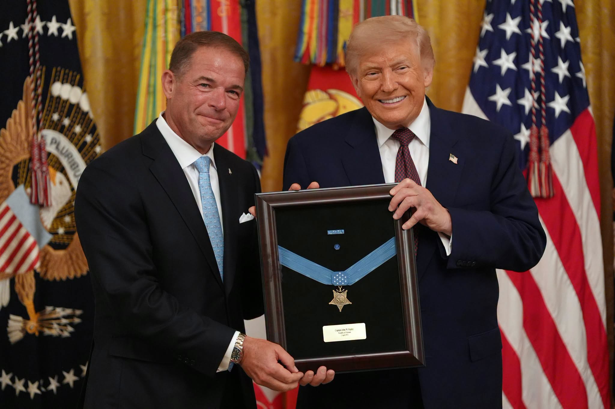 President Donald Trump, right, presents the Medal of Honor to Tom Ripley, who accepts on behalf of his late father Marine Col. John W. Ripley, in the East Room of the White House, Thursday, June 18, 2026, in Washington. (AP Photo/Jacquelyn Martin)