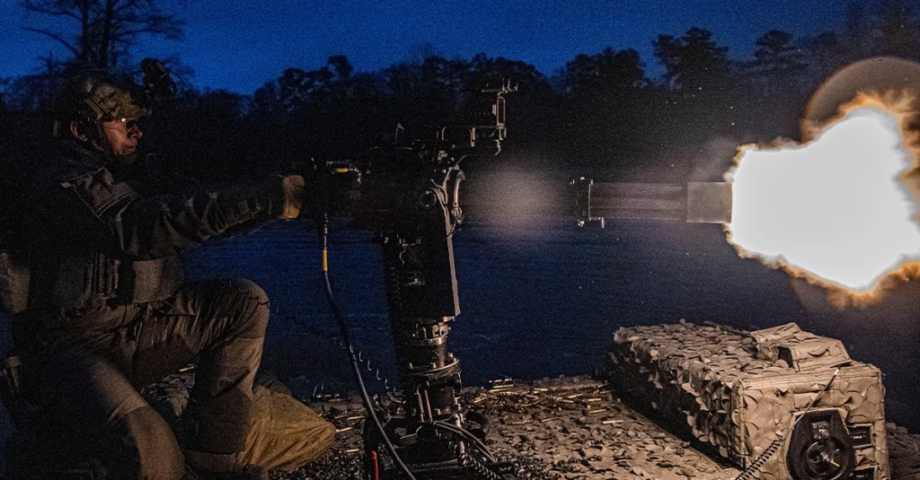 A Swedish special boat unit operator fires the M134 minigun during recent a night fire training scenario
