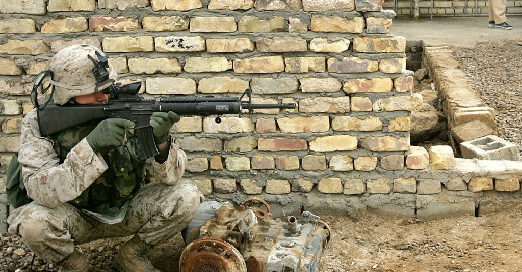 A U.S. Marine patrolling the Iraqi city of Yusufiyah, south of Baghdad, December 2004. The city is in the insurgent heartland called the "Triangle of Death."