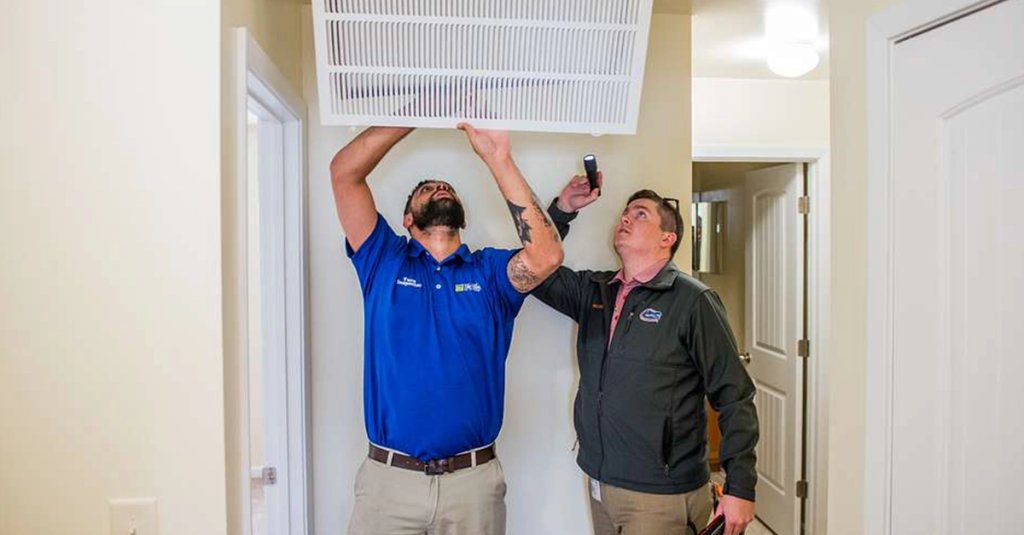 housing inspectors at Fort Benning check the condition of an air filter and HVAC return vent during a quality assurance inspection of a home being readied for occupancy.