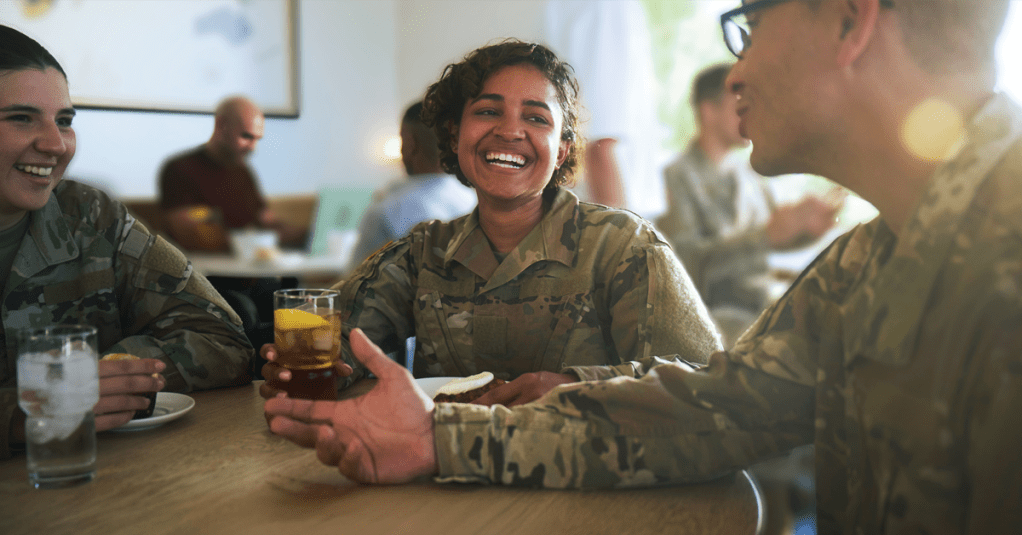 Military service members sharing a meal and conversation at a restaurant