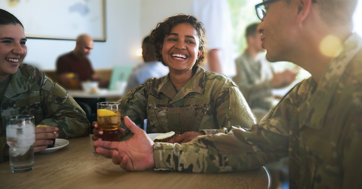 Military service members sharing a meal and conversation at a restaurant