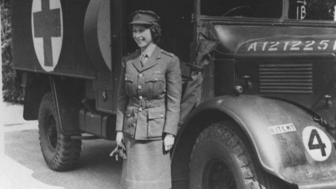 Queen Elizabeth II poses by a rescue vehicle during WWII. 