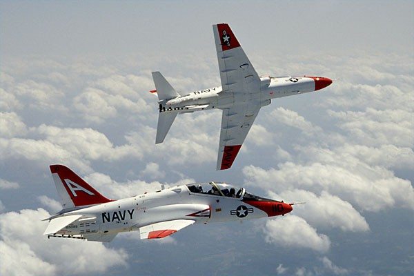 Two T-45 Goshawks fly through clouds