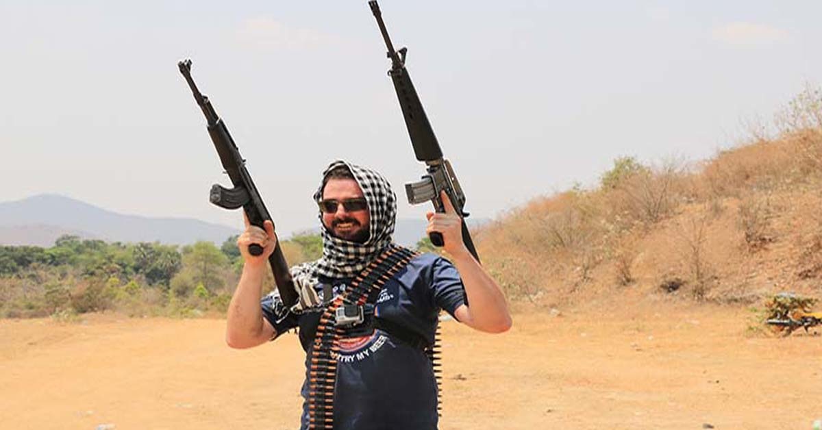 man with two large firearms